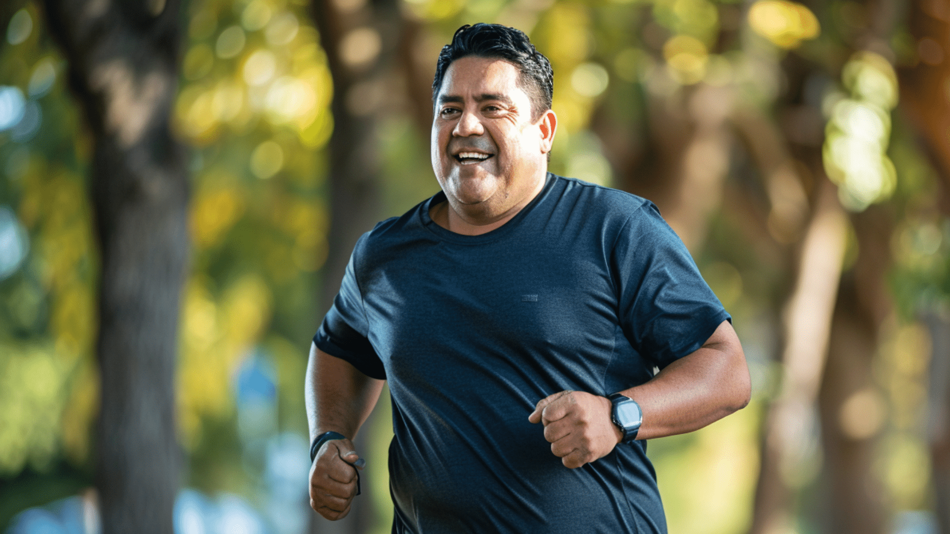 A 40-50 aged hispanic man running in a park.