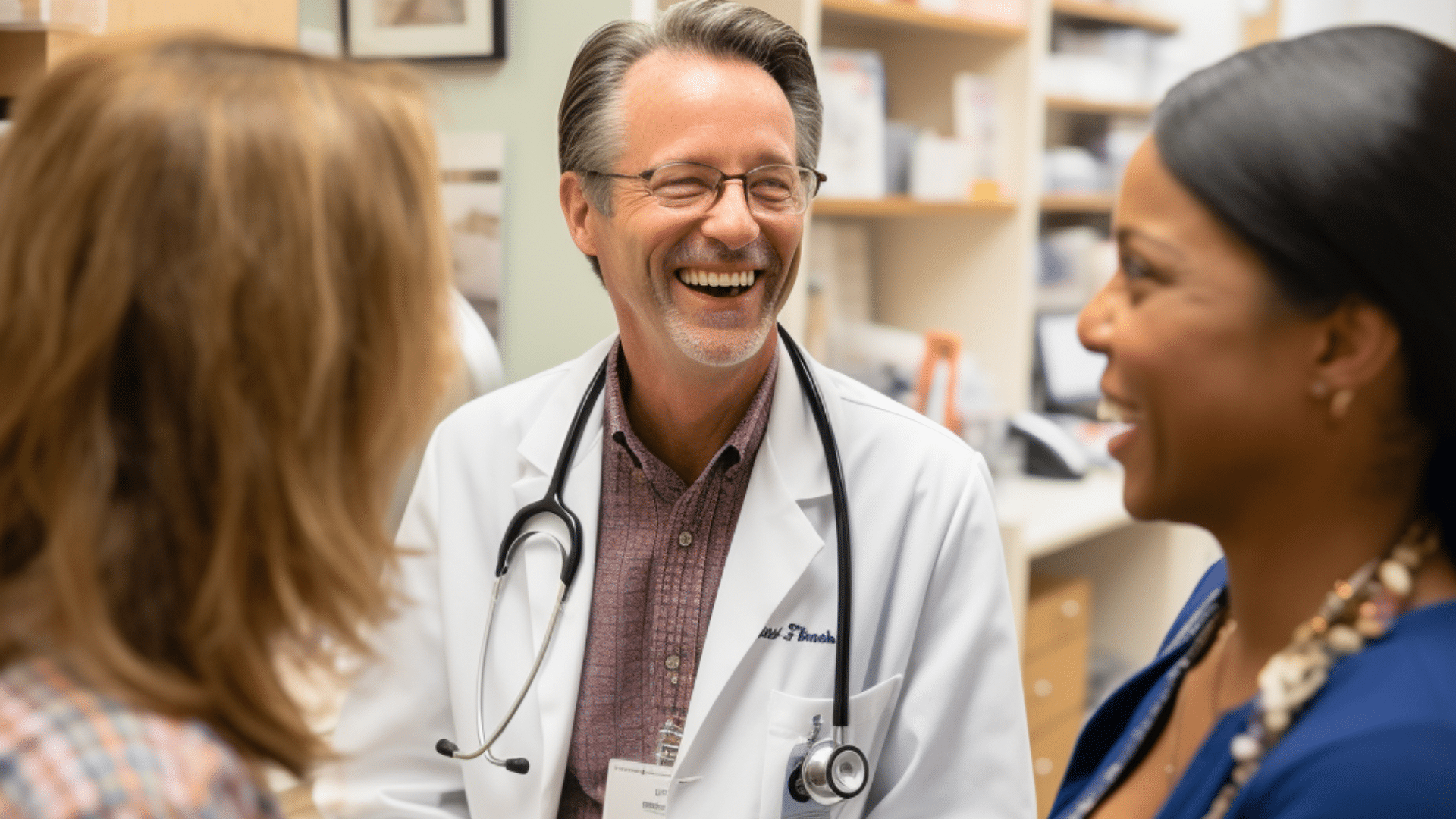 A smiling medical doctor engaged in a conversation with his patients.