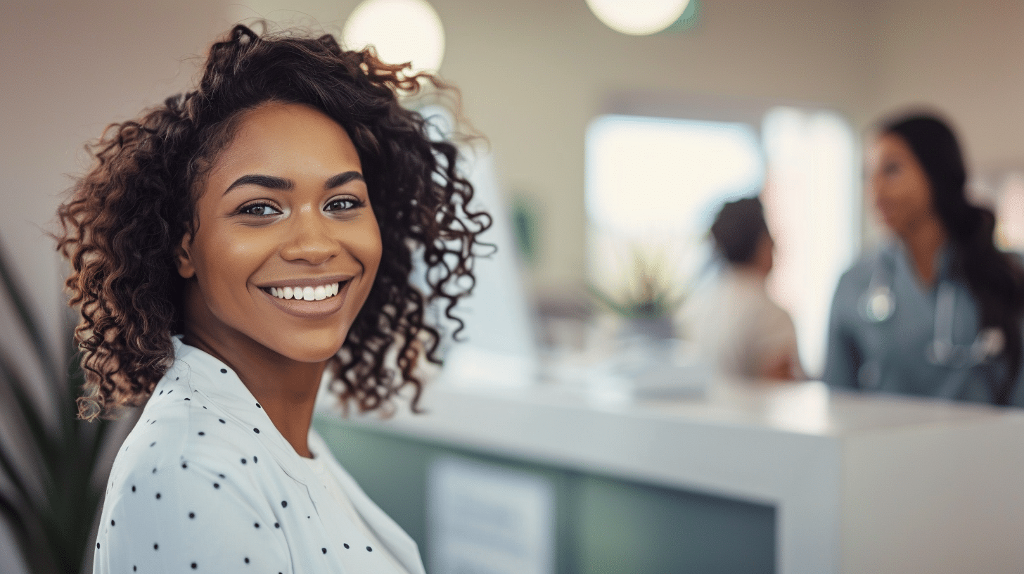 A smiling client standing in the clinic reception area.