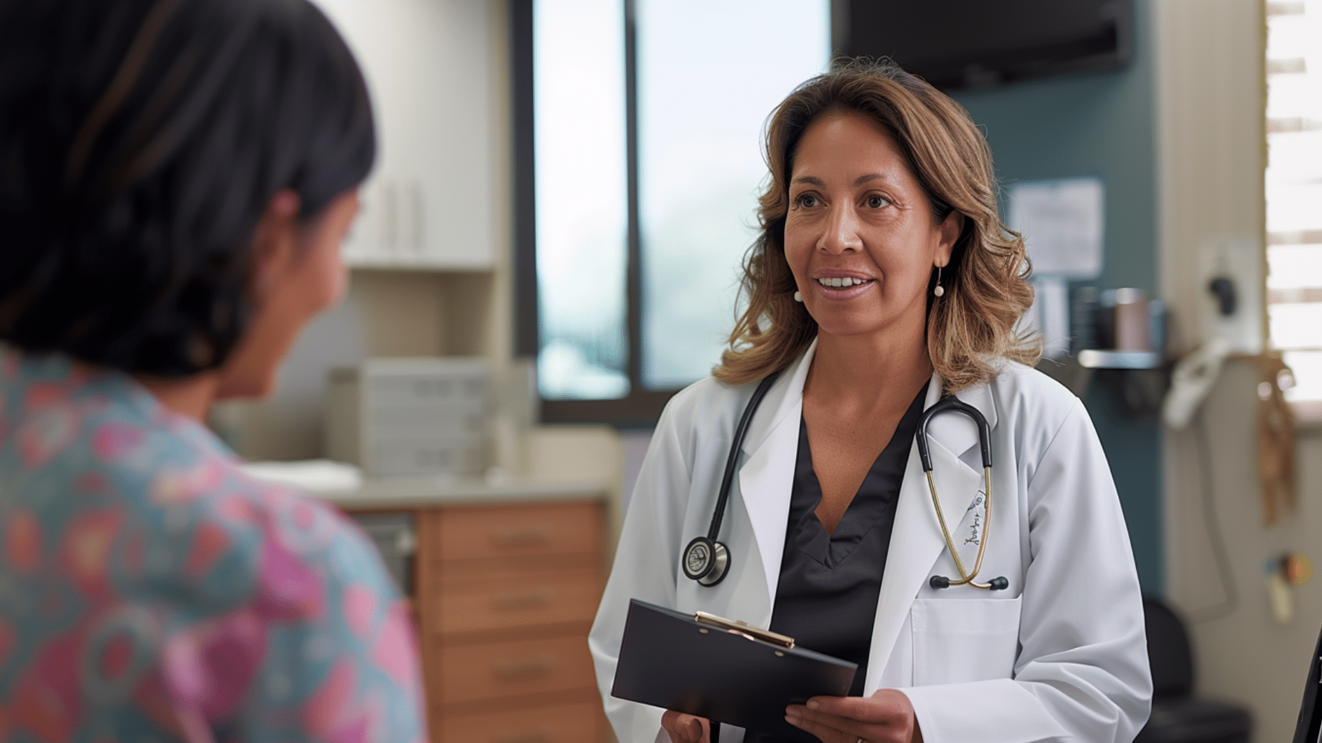 A doctor happily talking with her patient.