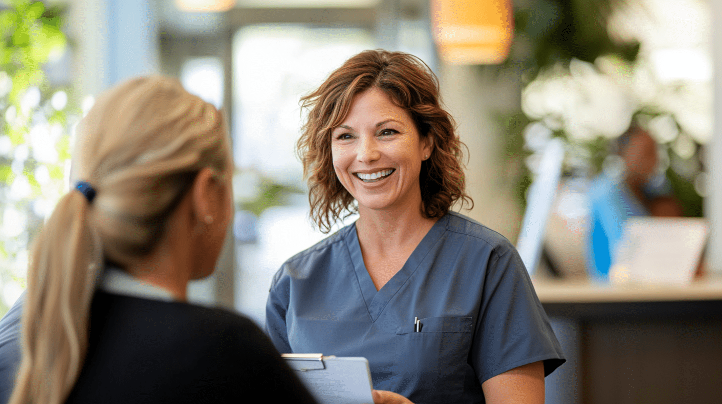 A smiling clinician assisting a patient during her clinic visit.