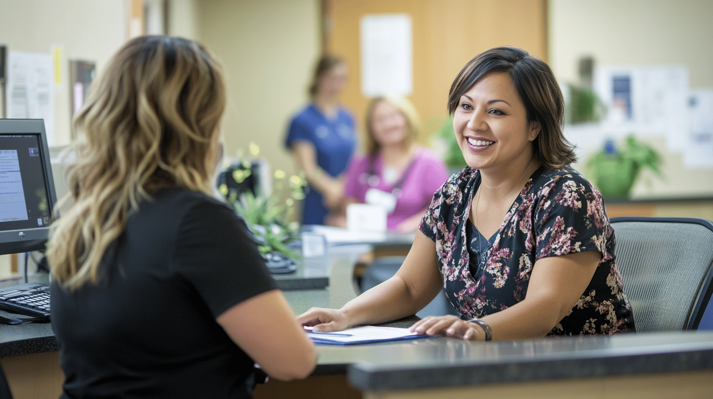 A female patient talking a nurse practitioner in the clinic lobby.